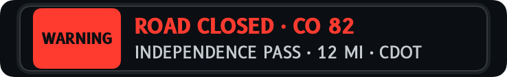 The alert row: a red WARNING tile and the message ROAD CLOSED · CO 82.